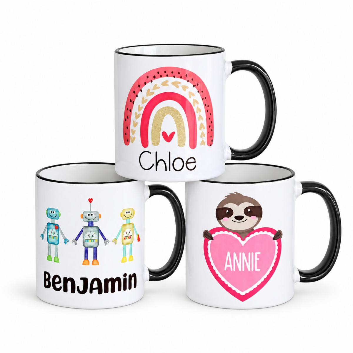 Personalized kids’ mugs featuring Rainbow, Robots, and Sloth designs on a white background.
