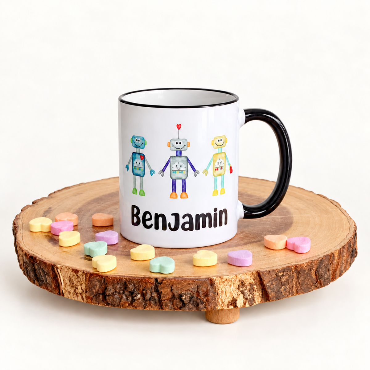 Personalized Robots kids’ mug with the name Benjamin, black handle, and black rim.